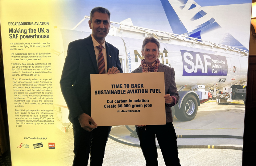 Trudy is standing with  the Director of Back Heathrow holding a pledge card that states it is time to back sustainable aviation fuel. 